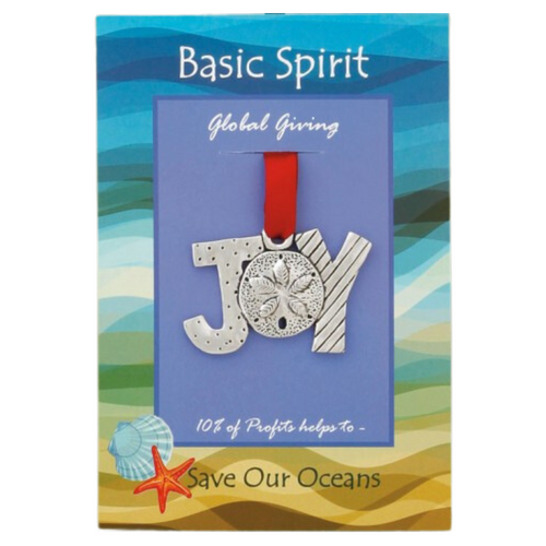 A pewter ornament that spells JOY is shown on a blue backing card with a red satin ribbon. The "O" is a sand dollar, the J is polka dots, and the Y is striped  