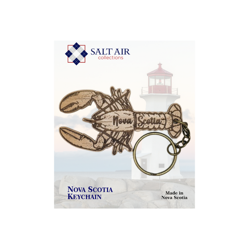 Nova Scotia lobster cutout keychain by salt air collections. made in Nova Scotia keychain that is shaped like a lobster and has the words Nova Scotia on the inside. made from alder wood